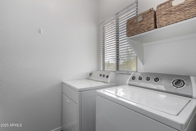 washroom with washing machine and clothes dryer