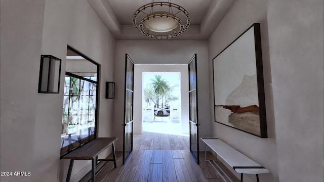 doorway featuring hardwood / wood-style flooring, french doors, and a tray ceiling