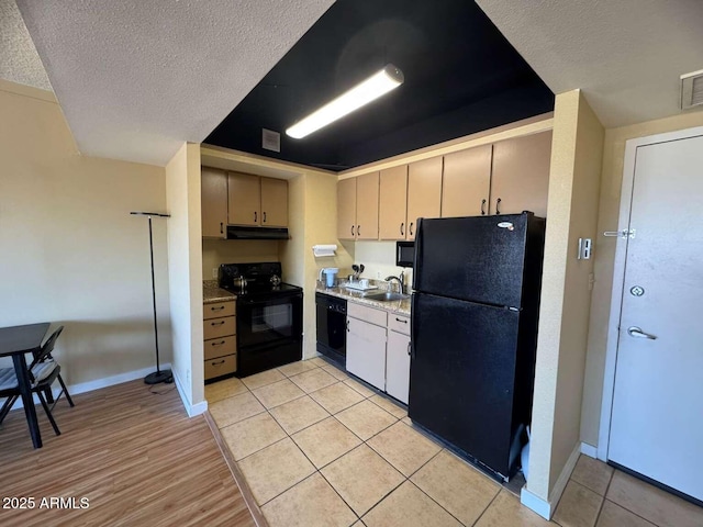 4750 N Central Ave Unit R3, Phoenix, AZ 85012 - kitchen with black appliances, a sink, under cabinet range hood, a textured ceiling, and light countertops