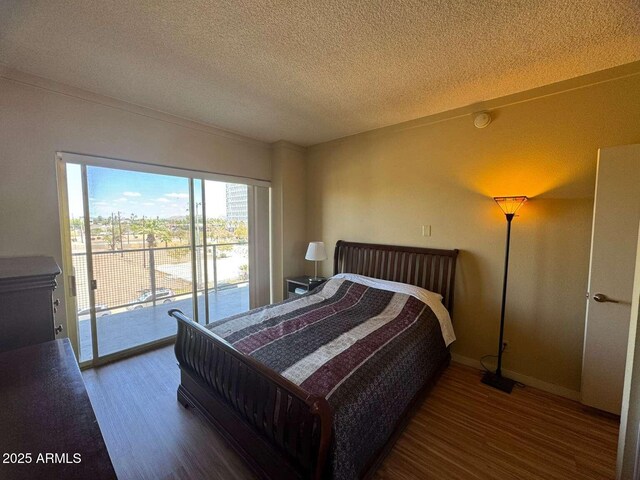 4750 N Central Ave Unit R3, Phoenix, AZ 85012 - bedroom with access to exterior, wood finished floors, a textured ceiling, and baseboards