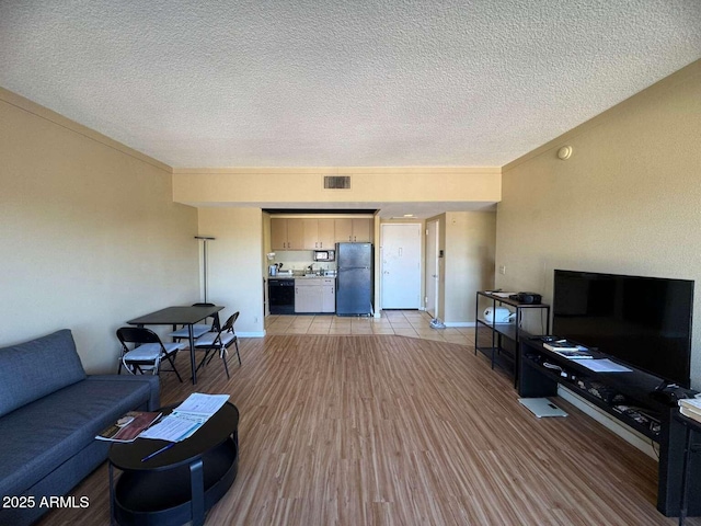 4750 N Central Ave Unit R3, Phoenix, AZ 85012 - living area featuring a textured ceiling, light wood-style flooring, and baseboards