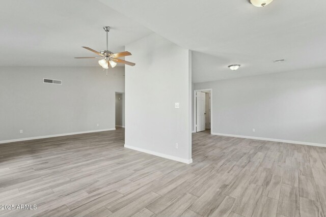 4634 W Aire Libre Ave, Glendale, AZ 85306 - empty room featuring visible vents, ceiling fan, baseboards, light wood-type flooring, and vaulted ceiling
