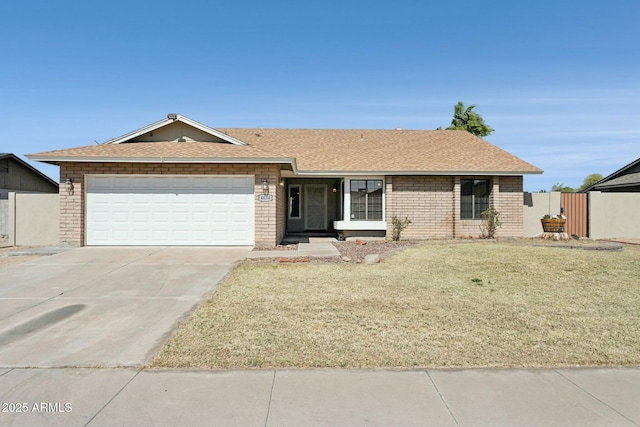 single story home featuring a front lawn, driveway, a shingled roof, a garage, and brick siding