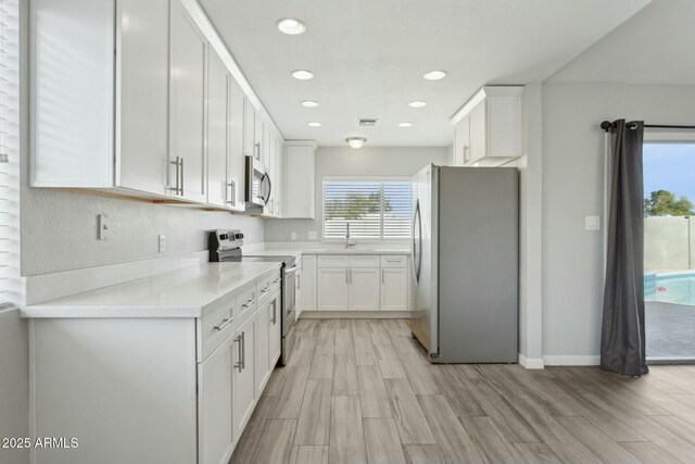 4634 W Aire Libre Ave, Glendale, AZ 85306 - kitchen featuring recessed lighting, white cabinets, appliances with stainless steel finishes, and light countertops