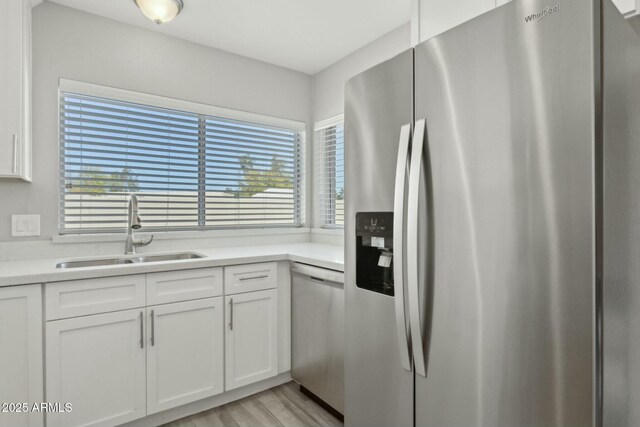 4634 W Aire Libre Ave, Glendale, AZ 85306 - kitchen with white cabinetry, light countertops, appliances with stainless steel finishes, and a sink