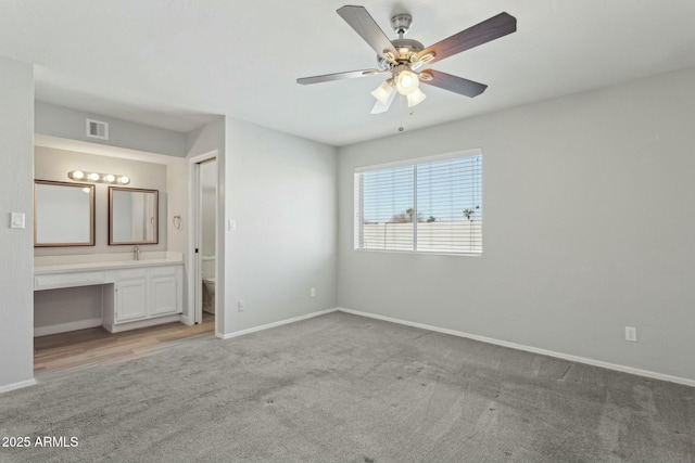 4634 W Aire Libre Ave, Glendale, AZ 85306 - unfurnished bedroom with visible vents, baseboards, light carpet, ensuite bath, and built in study area