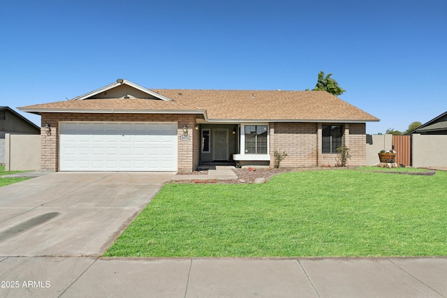 ranch-style house with a front yard, a shingled roof, concrete driveway, a garage, and brick siding