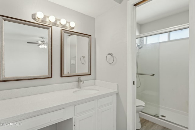 4634 W Aire Libre Ave, Glendale, AZ 85306 - bathroom featuring toilet, a ceiling fan, wood finished floors, a shower stall, and vanity
