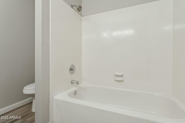 4634 W Aire Libre Ave, Glendale, AZ 85306 - full bath with shower / bathing tub combination, toilet, wood finished floors, and baseboards