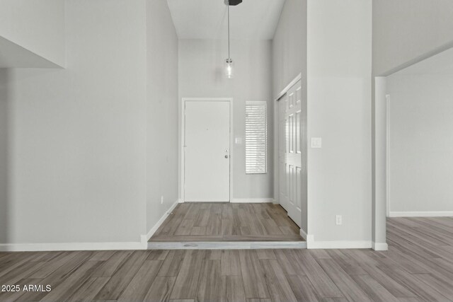4634 W Aire Libre Ave, Glendale, AZ 85306 - foyer featuring a high ceiling, wood finished floors, and baseboards