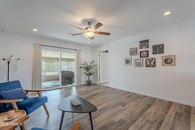 sitting room featuring wood-type flooring and ceiling fan