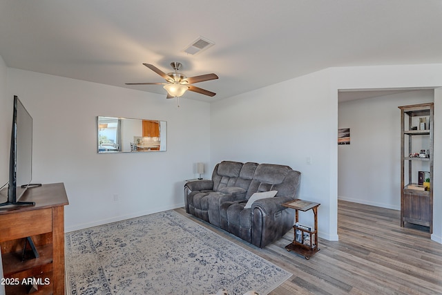 living room with hardwood / wood-style flooring and ceiling fan