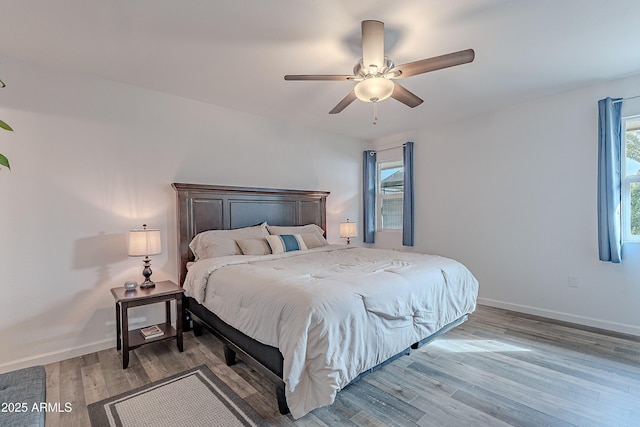 bedroom with ceiling fan and light hardwood / wood-style floors