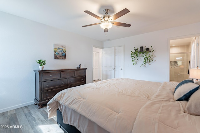 bedroom featuring connected bathroom, ceiling fan, and light wood-type flooring