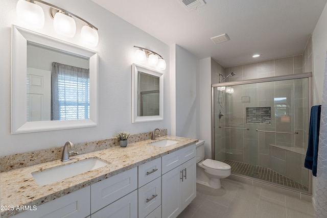 bathroom with tile patterned floors, toilet, an enclosed shower, and vanity