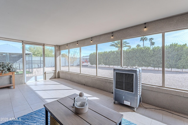 unfurnished sunroom with heating unit