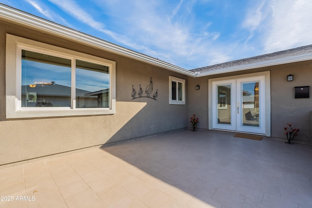 entrance to property featuring a patio area and french doors