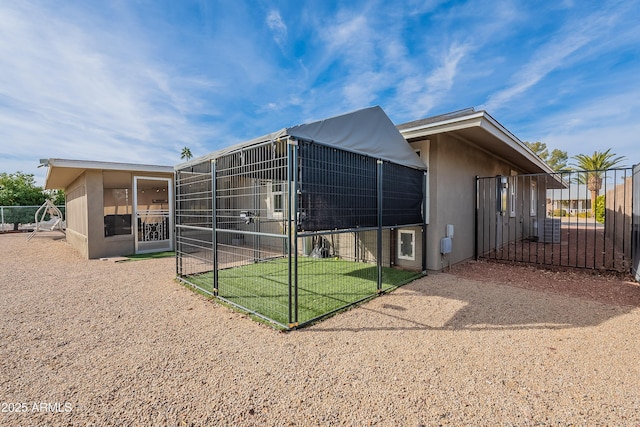 rear view of property featuring an outbuilding