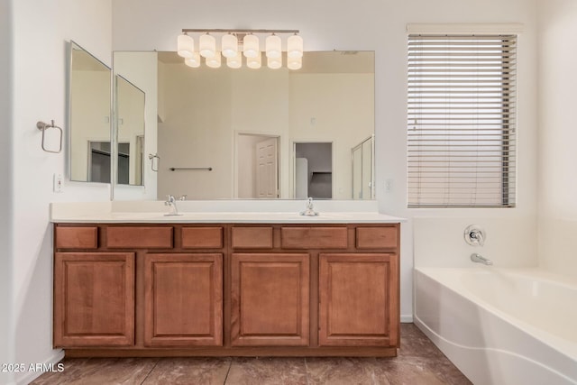 full bathroom with a garden tub, a sink, double vanity, and baseboards