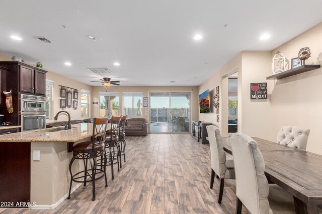 dining area featuring sink, ceiling fan, and light hardwood / wood-style floors