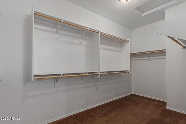 spacious closet with carpet floors and attic access