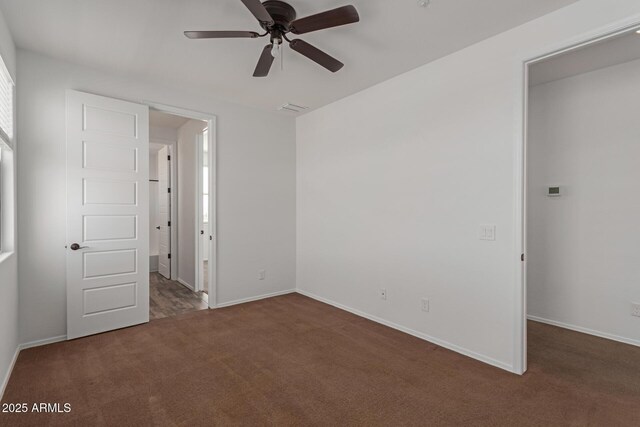 unfurnished bedroom featuring visible vents, carpet floors, baseboards, and a ceiling fan