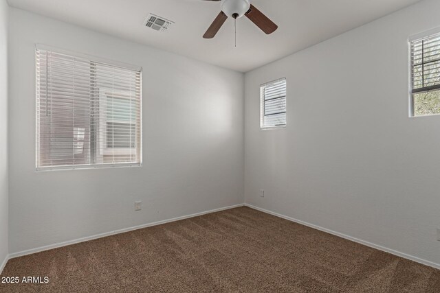 spare room featuring visible vents, baseboards, carpet, and a ceiling fan