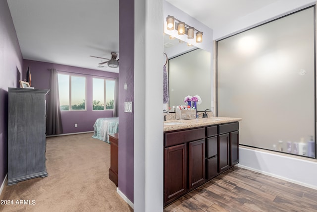 bathroom featuring vanity, wood-type flooring, and ceiling fan