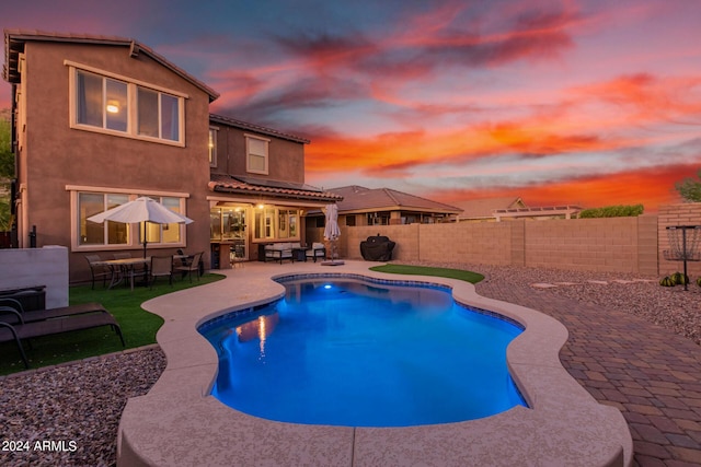 view of swimming pool with a patio area, a fenced in pool, and a fenced backyard