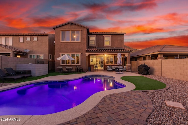 view of swimming pool with a patio area, a fenced in pool, outdoor dining area, and a fenced backyard