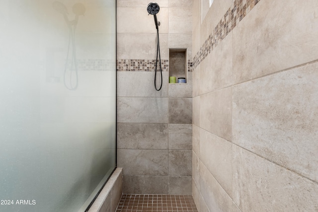 bathroom with a tile shower