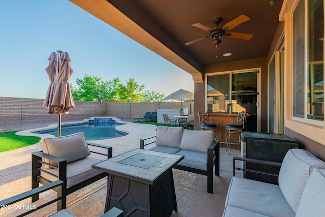 view of patio featuring an outdoor living space, a ceiling fan, a fenced backyard, and a fenced in pool