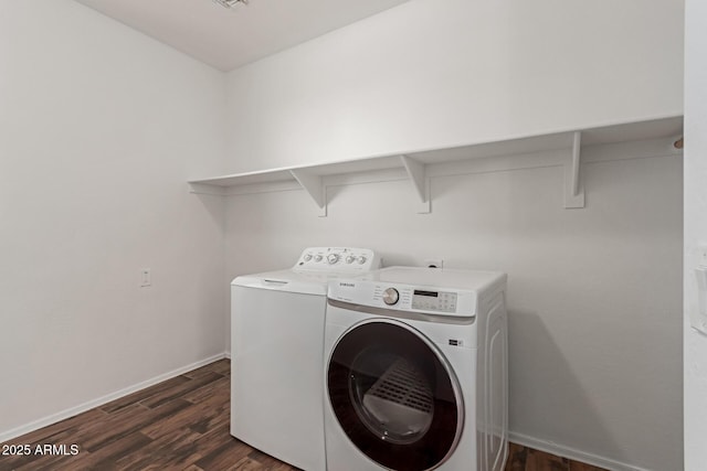 laundry area featuring washer and dryer, baseboards, dark wood-style flooring, and laundry area