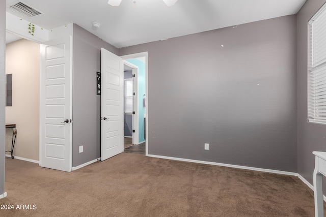 unfurnished bedroom with ceiling fan and carpet floors