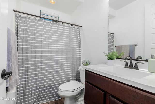 bathroom featuring vanity, toilet, a shower with curtain, and hardwood / wood-style floors