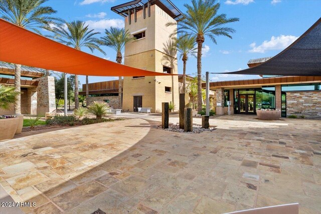 pool at dusk featuring a patio area and an outdoor hangout area