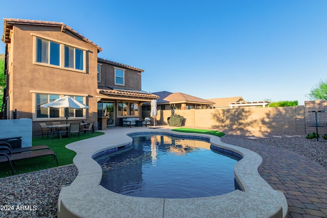 view of swimming pool featuring area for grilling and a patio area