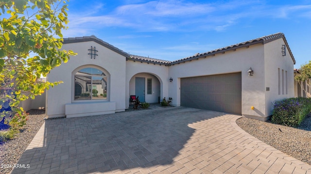 mediterranean / spanish house with a garage