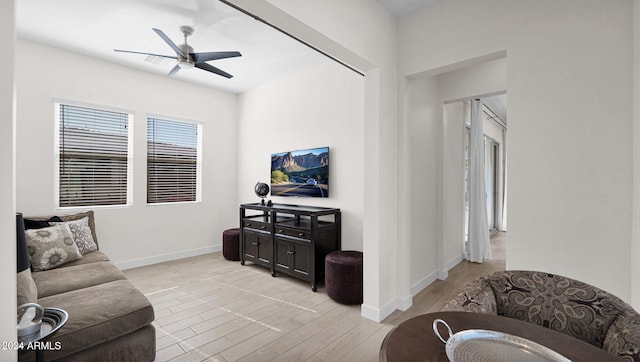 living room featuring ceiling fan and light wood-type flooring