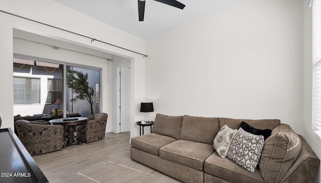 living room featuring ceiling fan, light hardwood / wood-style floors, and a healthy amount of sunlight