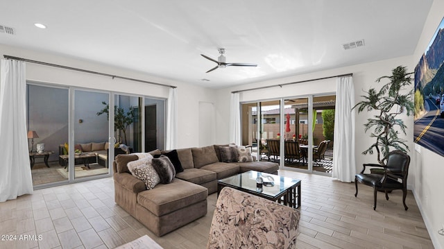 living room featuring ceiling fan and light hardwood / wood-style flooring