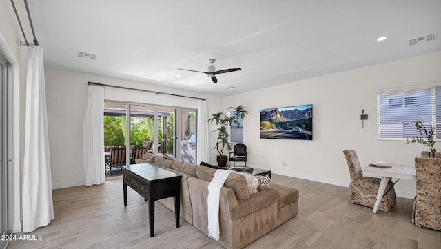 living room featuring ceiling fan and light hardwood / wood-style flooring