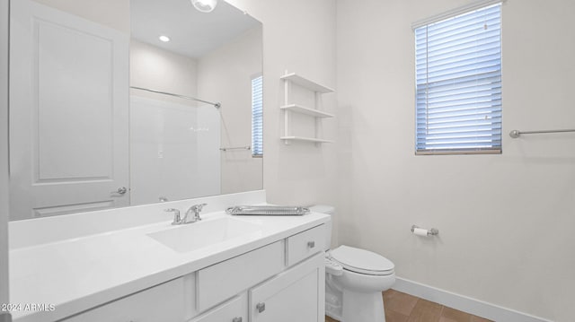 bathroom featuring walk in shower, hardwood / wood-style floors, vanity, and toilet