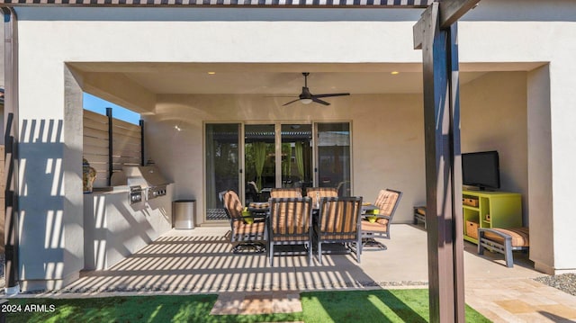 view of patio featuring ceiling fan and exterior kitchen