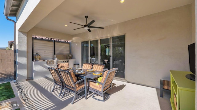 view of patio / terrace with ceiling fan and exterior kitchen