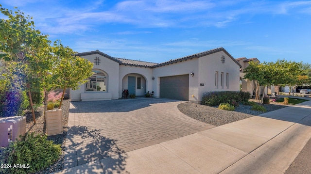 mediterranean / spanish-style house with a garage