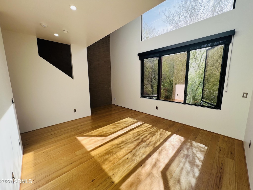 unfurnished room with wood finished floors and recessed lighting