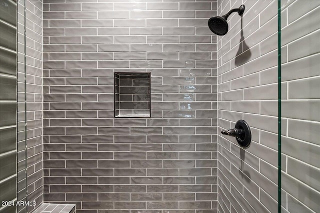 full bath with a tile shower