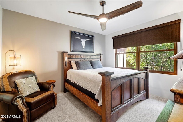 bedroom featuring ceiling fan and light carpet