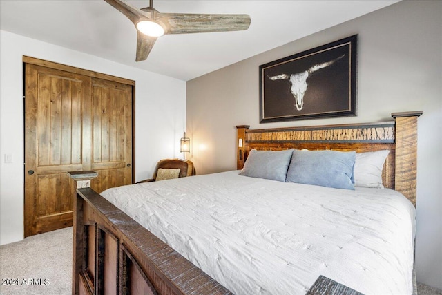 carpeted bedroom featuring a closet and ceiling fan